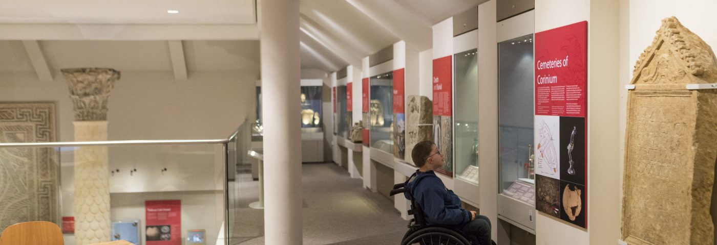 Man in wheelchair looking at exhibit